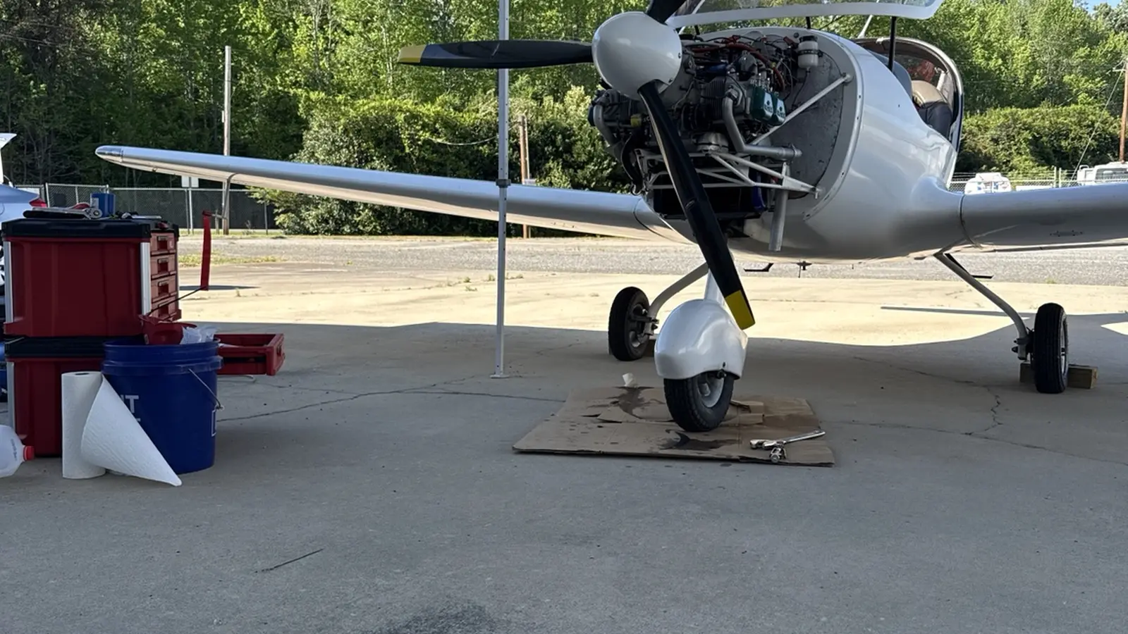 Light-sport aircraft with its cowling open during field service
