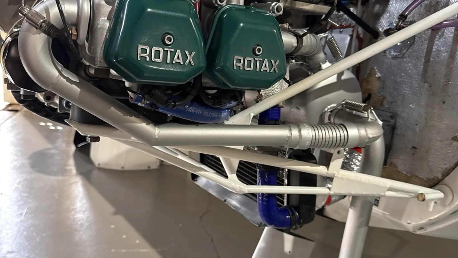 Installed ROTAX engine with green valve covers in a light-sport aircraft