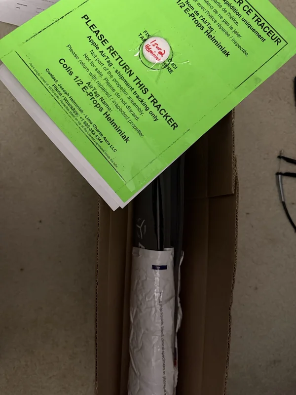 E-PROPS return tracker with propeller blades and shipping box