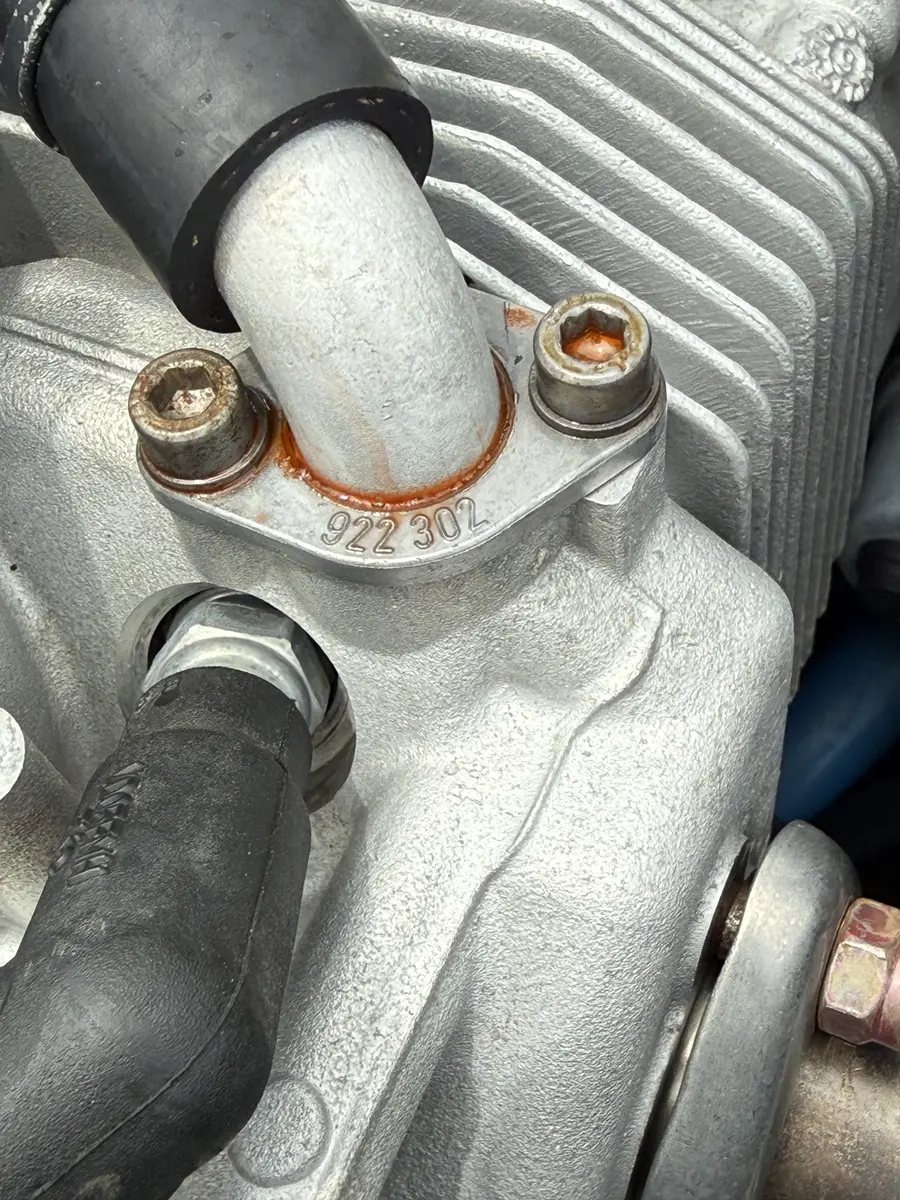 Coolant residue at a ROTAX cylinder head hose area during leak tracing