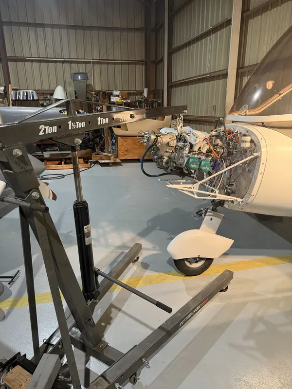 ROTAX engine supported on a hoist during aircraft maintenance