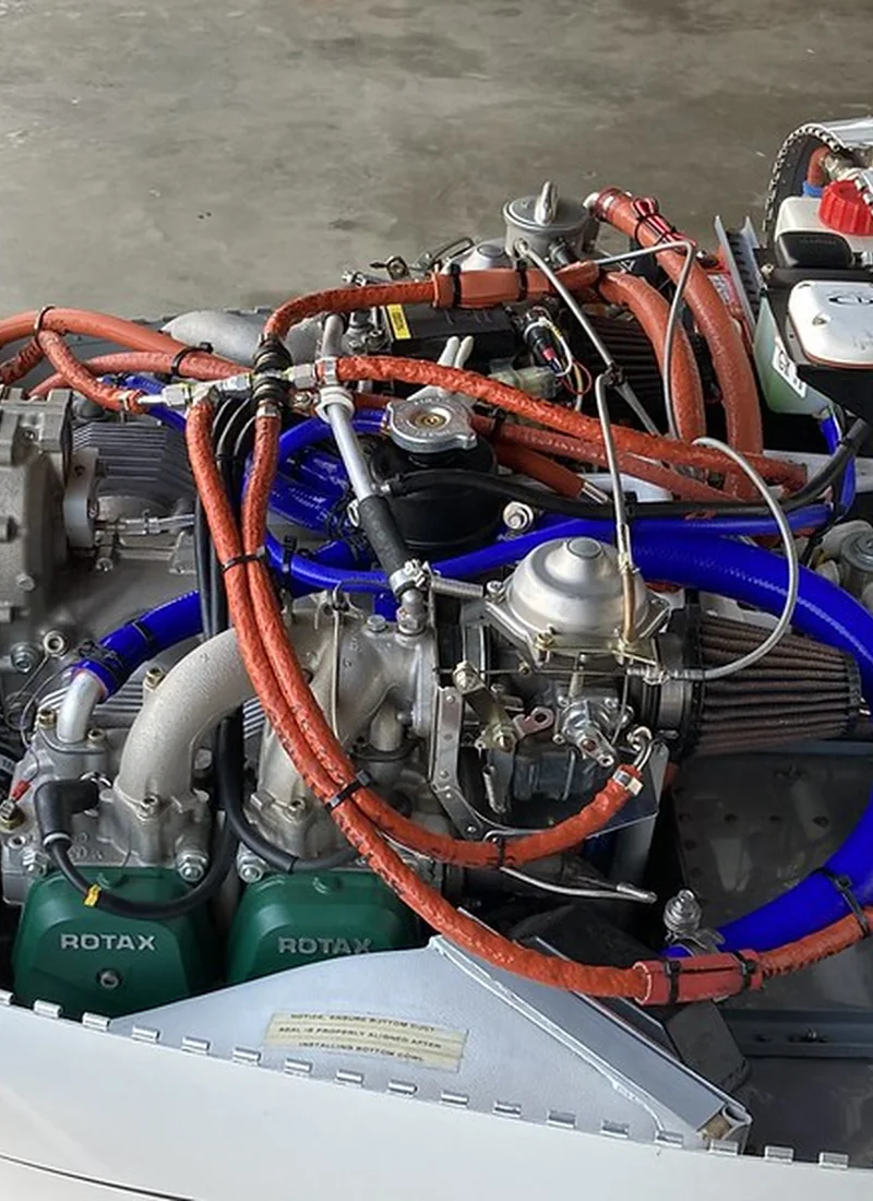 Installed ROTAX engine overview showing fuel, coolant, and intake hose routing for rubber package planning