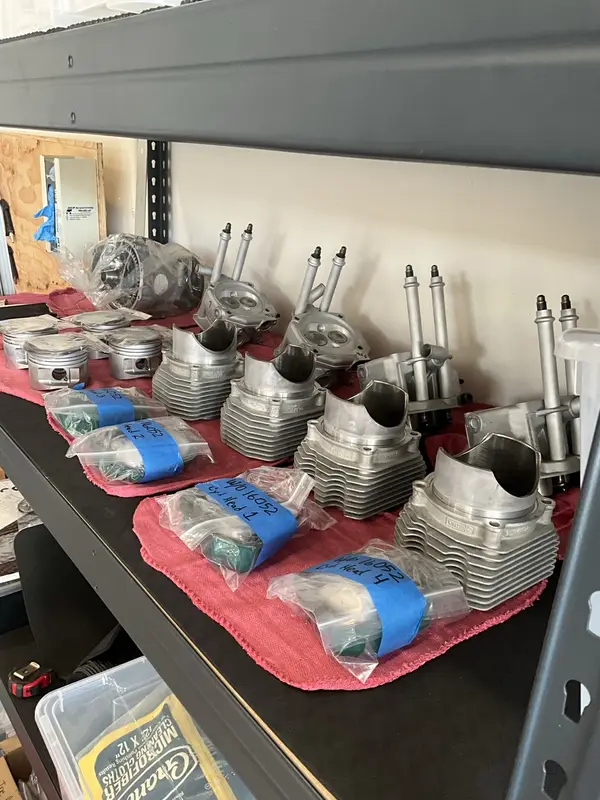 ROTAX top-end parts organized in sequence on a shop shelf