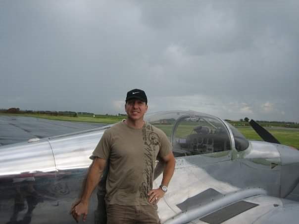 Joseph Joe Helminiak at an airfield beside a light-sport aircraft